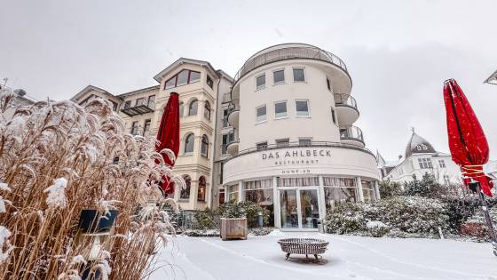 Hotelansicht DAS AHLBECK HOTEL & SPA im Winter mit Schnee und Feuerschale